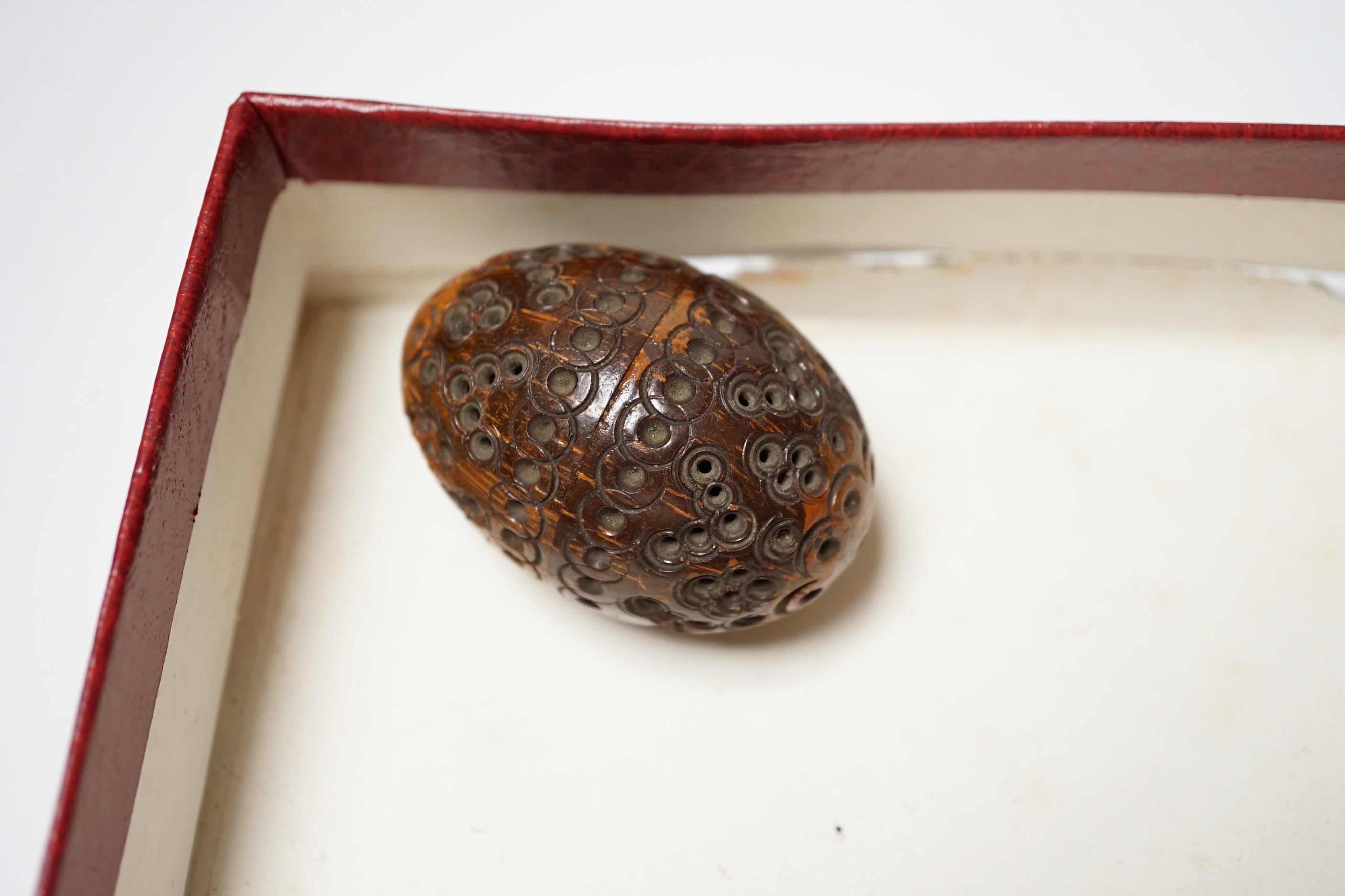 A Lennie brass pocket barometer, a carved coquilla nut, a silver plated napkin ring and two exhibition medallions